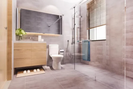 Salle de bain sur mesure avec des éléments en bois, miroir éclairé et une immense douche à l'italienne, offrant une esthétique chaleureuse et contemporaine. Le bois naturel crée une atmosphère accueillante, tandis que le miroir éclairé ajoute une touche de modernité